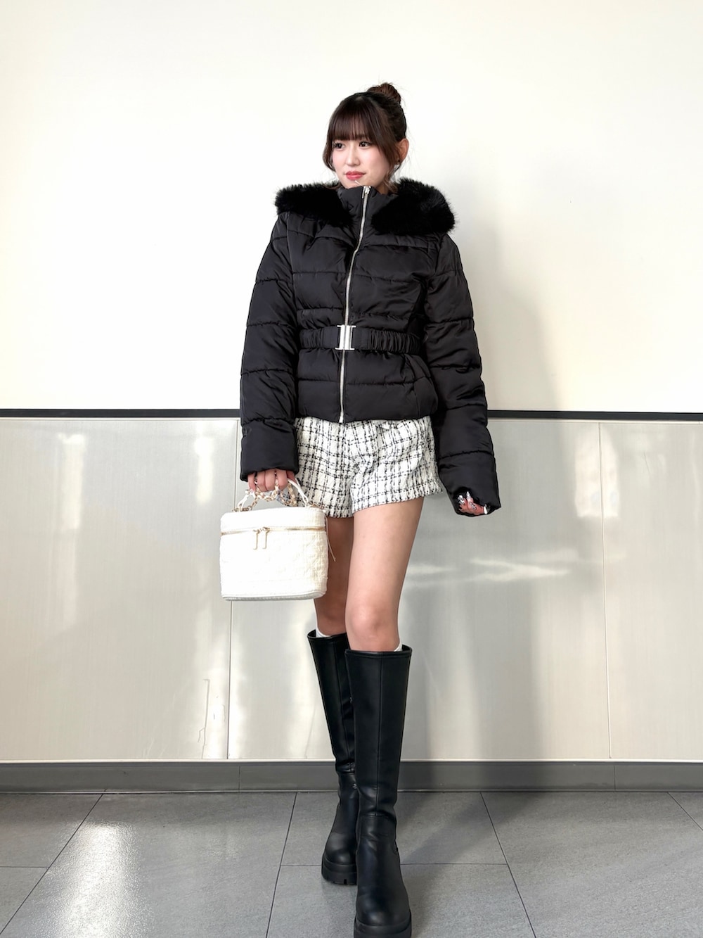 ブラック系のダウンジャケット/コート、ホワイト系のその他パンツ、ブラック系のブーツを着用したレディースの秋コーディネートの2枚目の写真