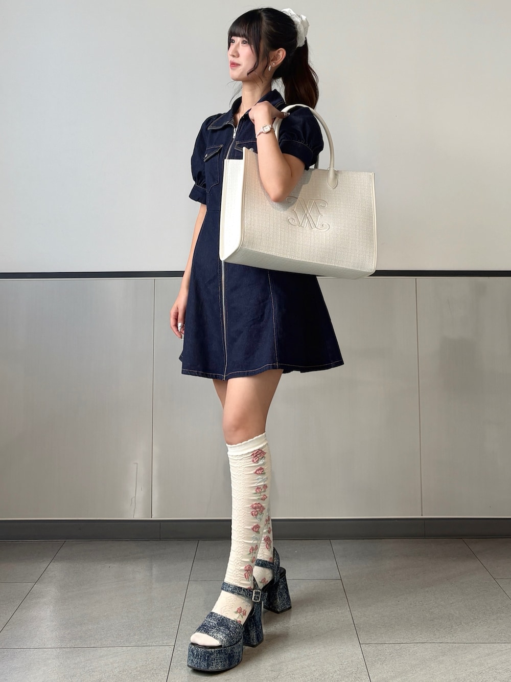 ブルー系のワンピース、ホワイト系のトートバッグ、ホワイト系のその他ヘアアクセサリーを着用したレディースの春コーディネートの2枚目の写真