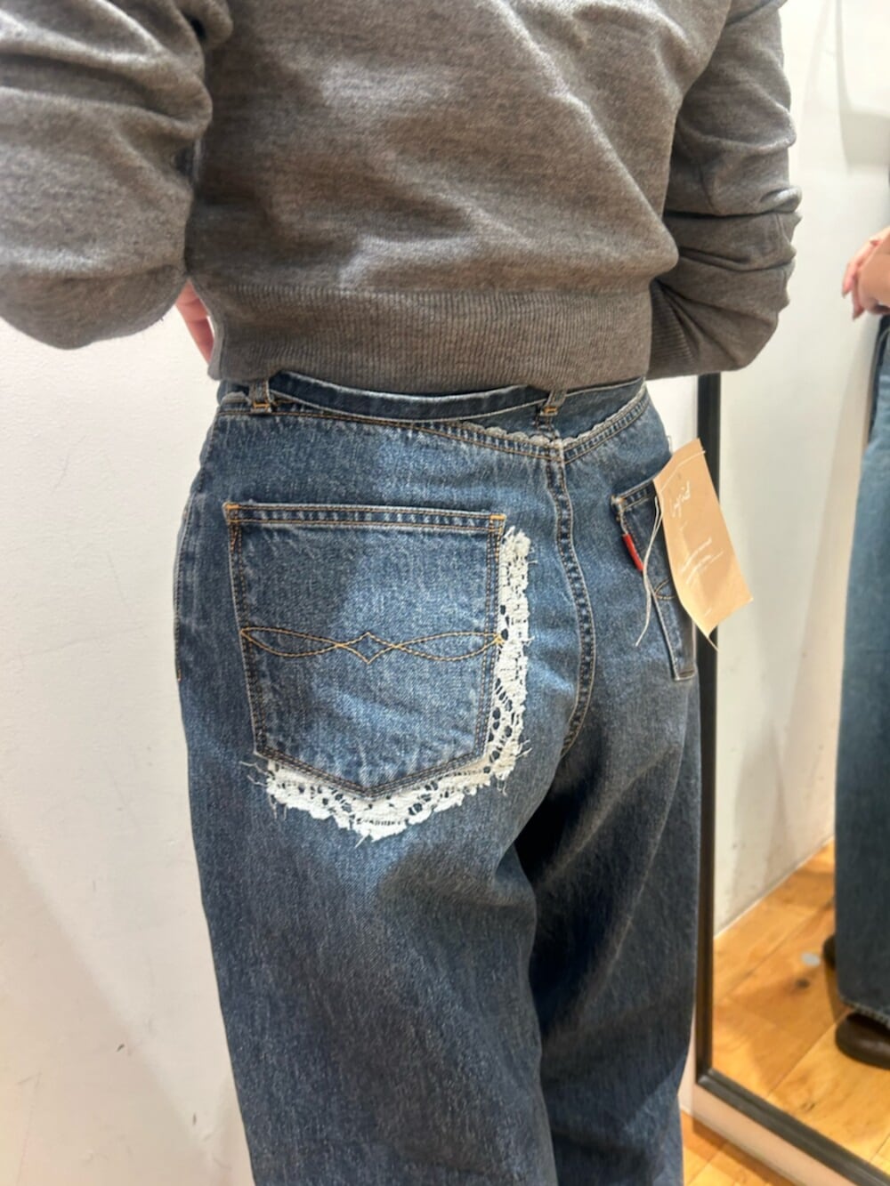 ブルー系のデニムパンツ、グレー系のカーディガン/ボレロを着用したレディースの秋コーディネートの4枚目の写真