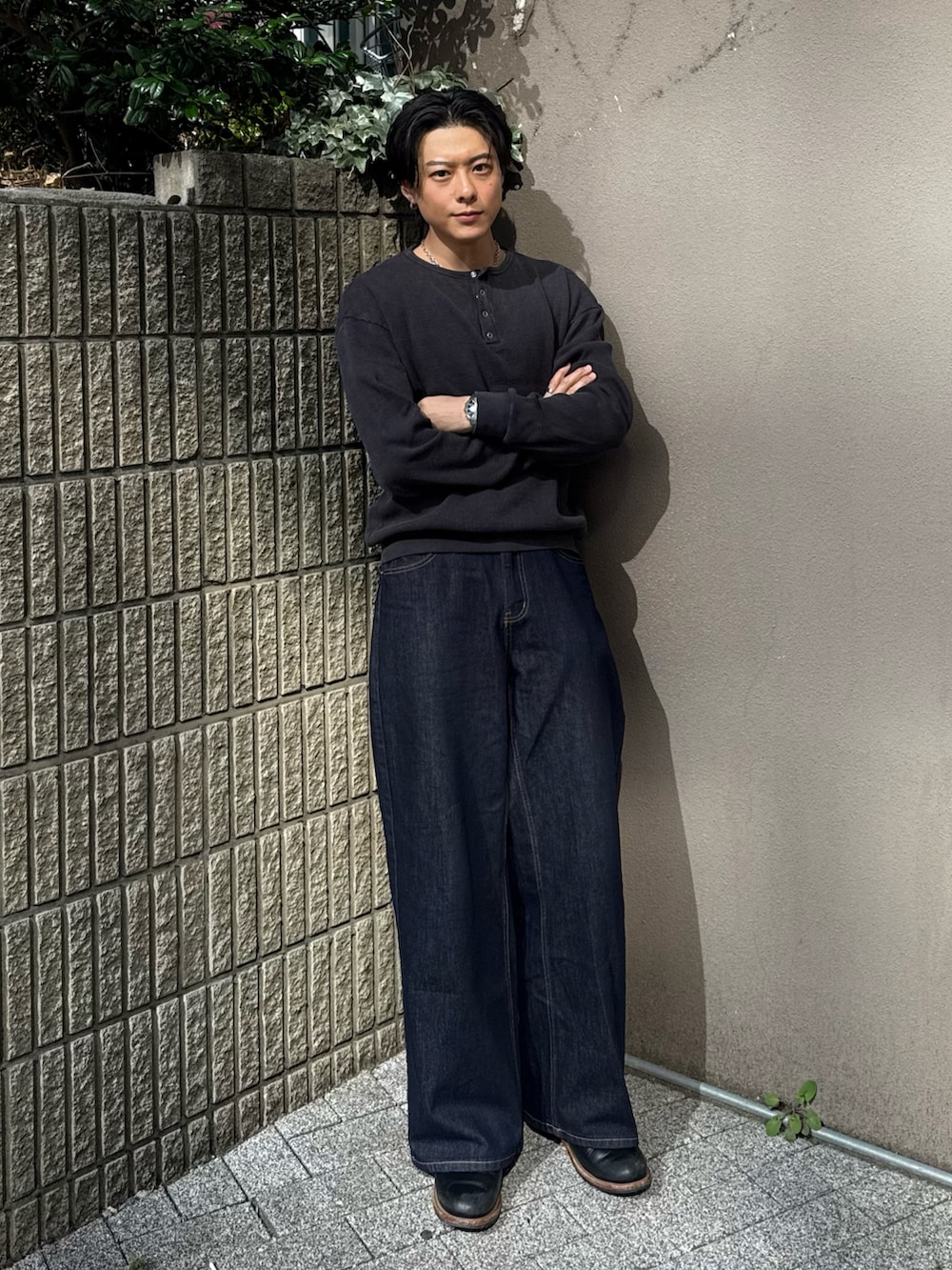 ブラック系のTシャツ/カットソー、ブルー系のパンツ、ブラック系のブーツを着用したメンズの春コーディネートの2枚目の写真