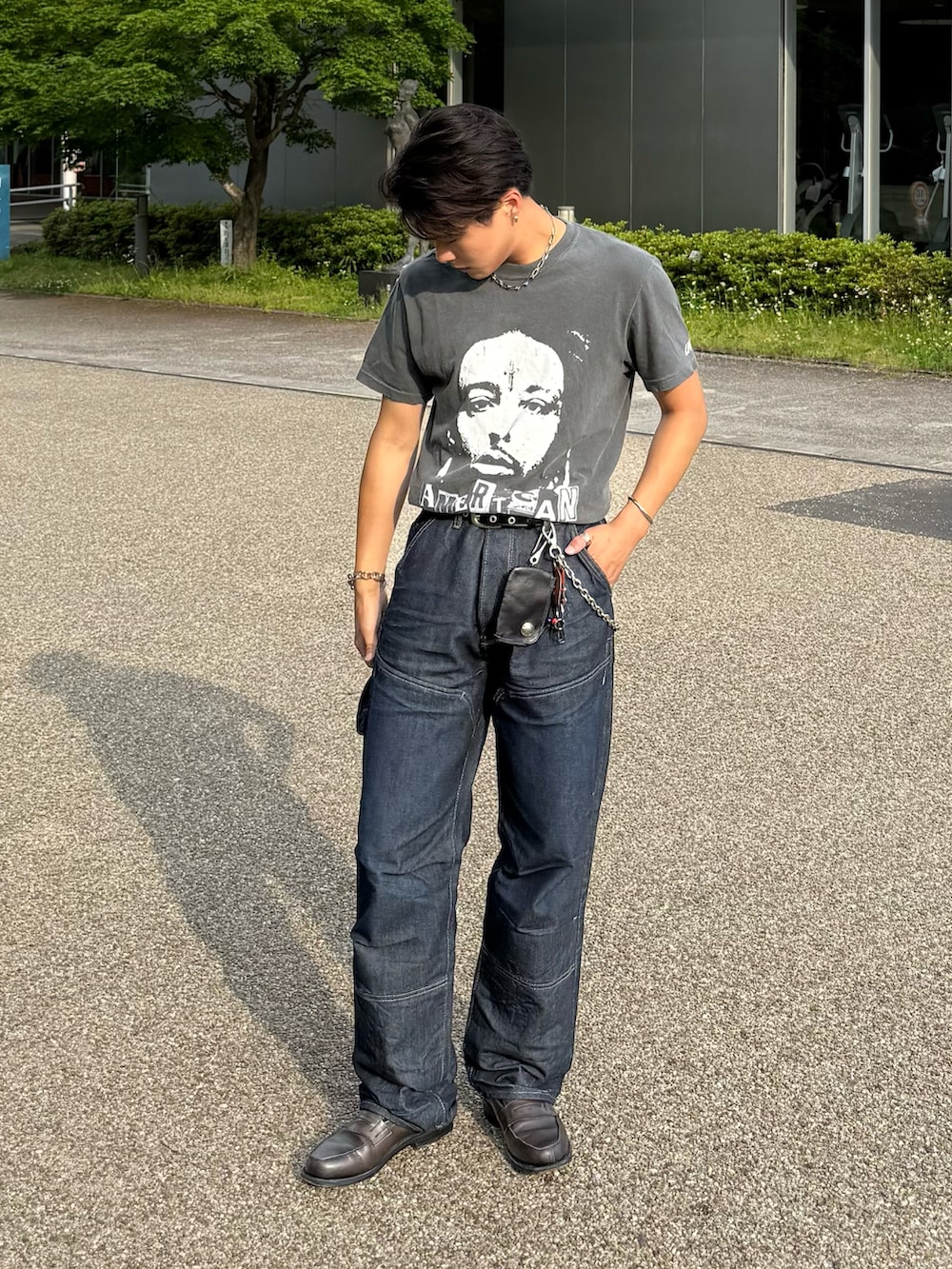 ブラック系のTシャツ/カットソー、ブルー系のデニムパンツ、グレー系のローファーを着用したメンズの春コーディネートの3枚目の写真