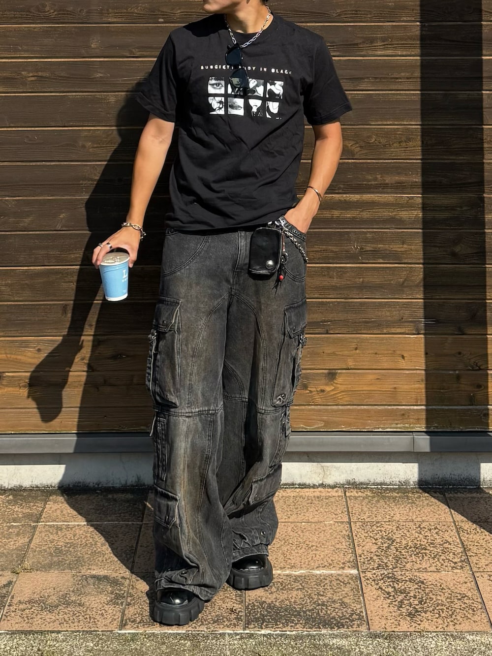ブラック系のTシャツ/カットソー、ブラック系のデニムパンツ、ブラック系のブーツを着用したメンズの夏コーディネートの2枚目の写真