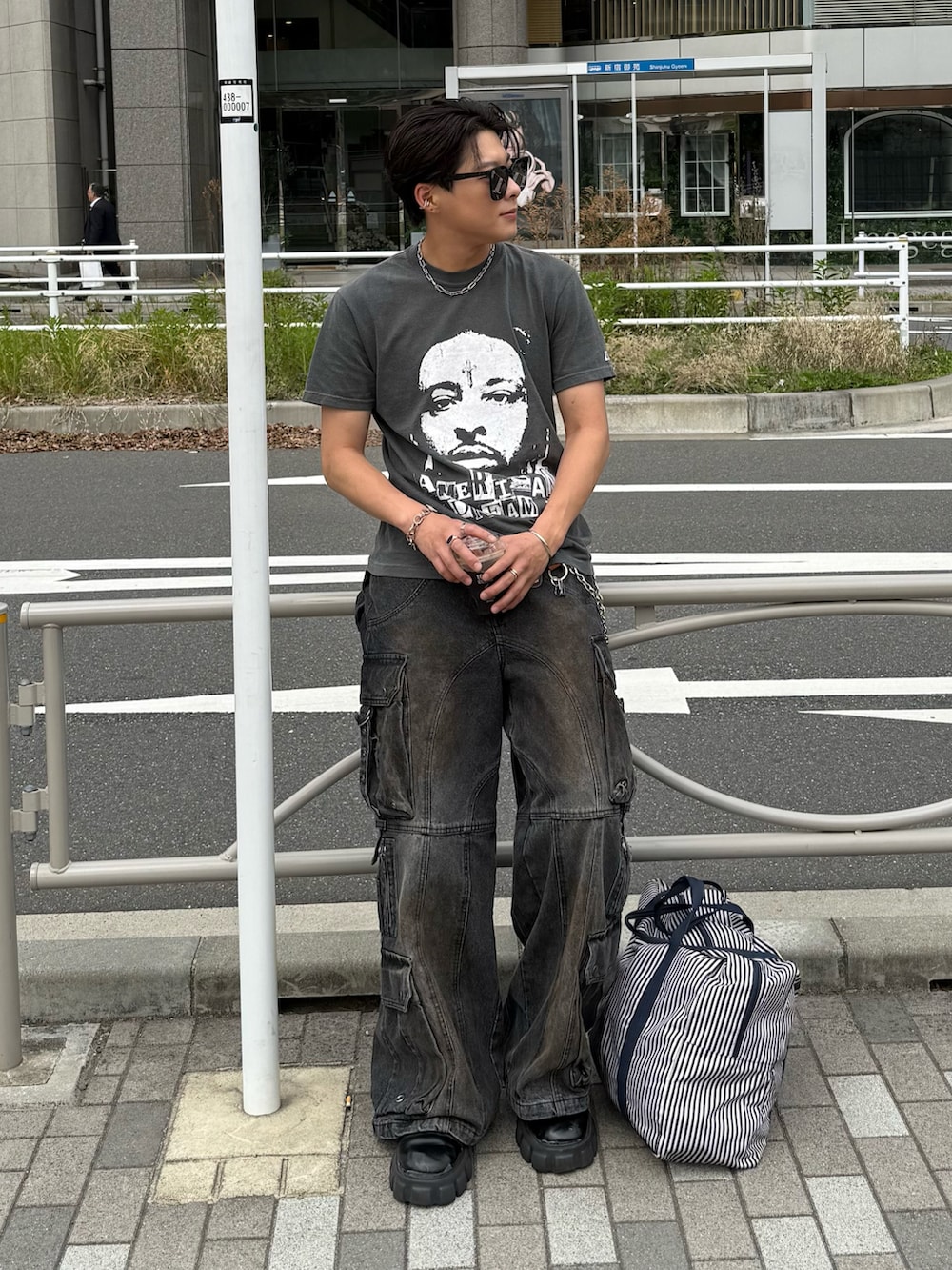 ブラック系のTシャツ/カットソー、ブラック系のデニムパンツ、ブラック系のブーツを着用したメンズの春コーディネートの3枚目の写真