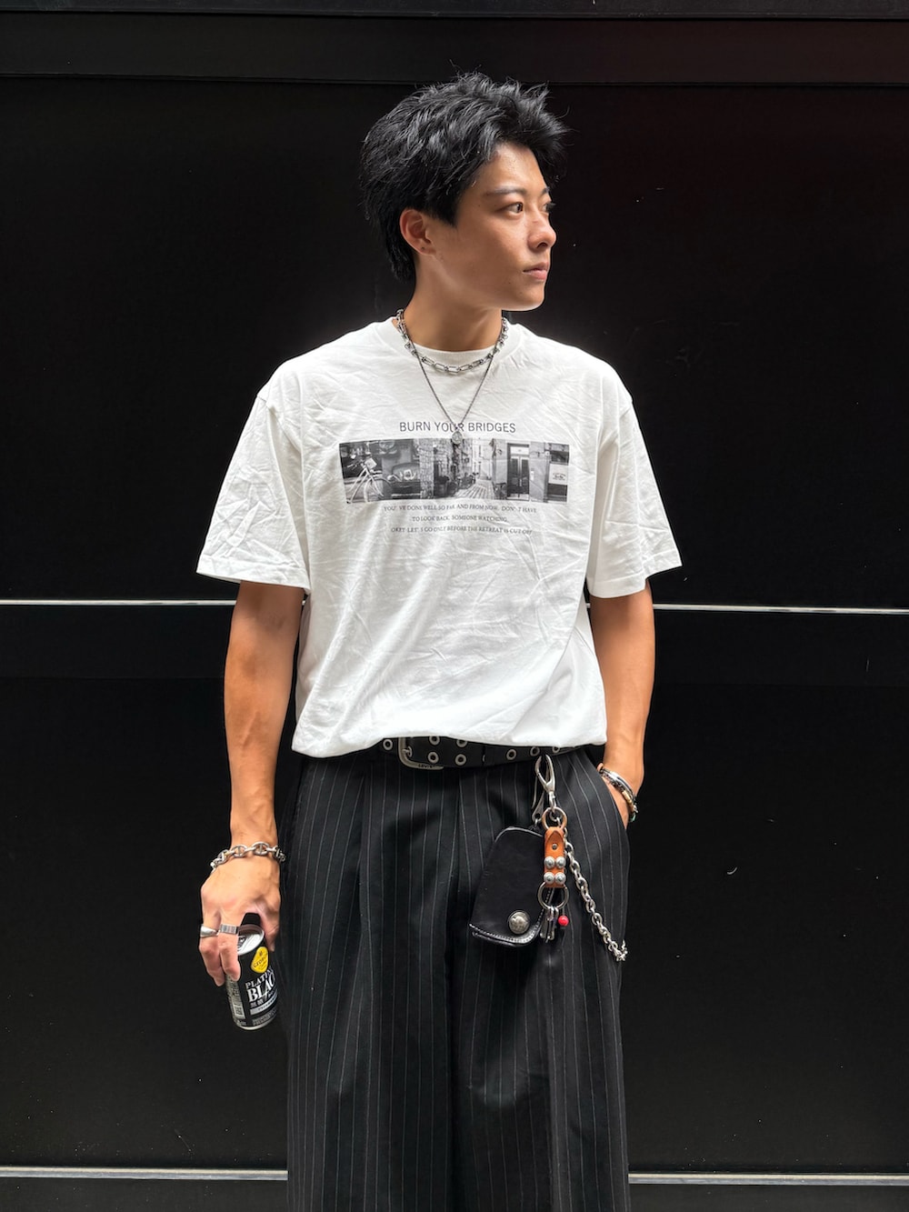ブラック系のスラックス、レッド系のローファー、ホワイト系のTシャツ/カットソーを着用したメンズの夏コーディネートの3枚目の写真