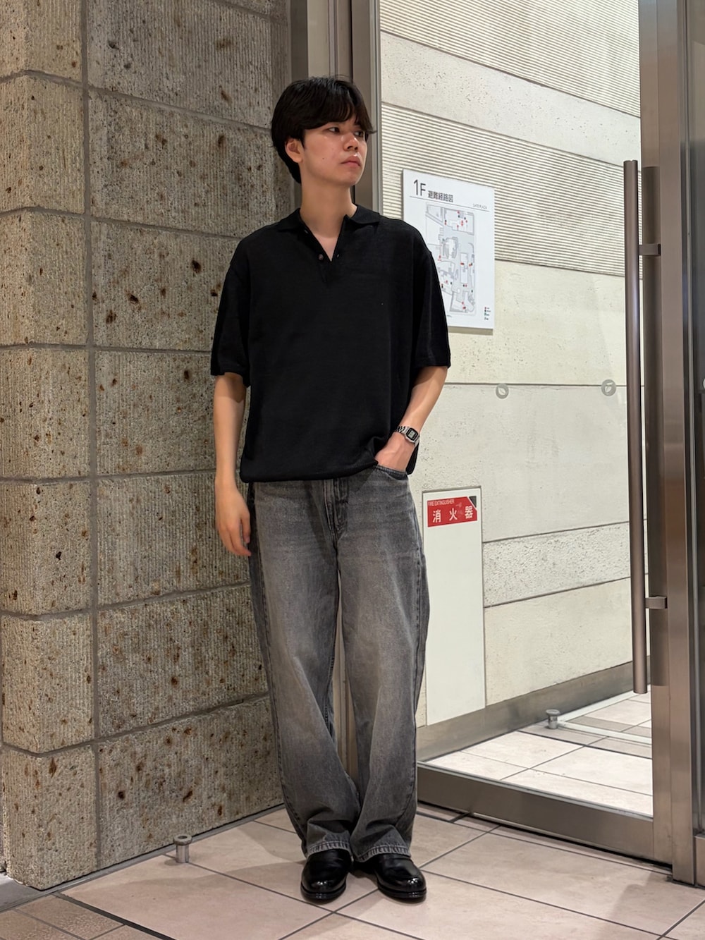 ブラック系のニット/セーター、ブラック系のデニムパンツ、ブラック系のドレスシューズを着用したメンズの夏コーディネートの2枚目の写真
