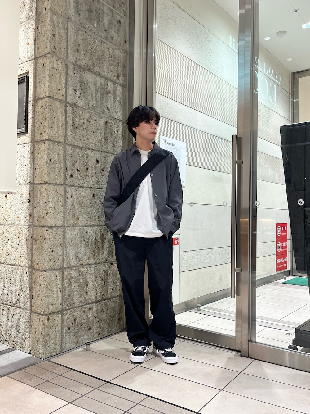 ブラック系のその他パンツ、ブラック系のスニーカー、ホワイト系のTシャツ/カットソーを着用したメンズの秋コーディネートの3枚目の写真