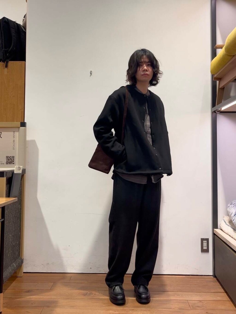 ブラウン系のショルダーバッグ、ブラック系のその他パンツ、ブラック系のカーディガン/ボレロを着用したメンズの冬コーディネートの2枚目の写真
