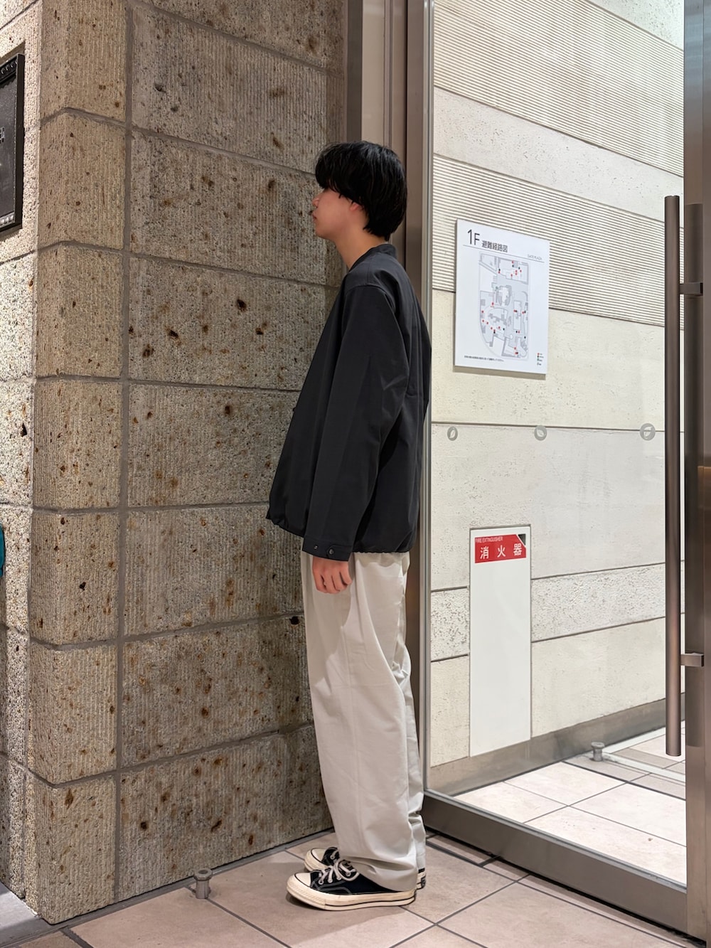 ブラック系のTシャツ/カットソー、ホワイト系のその他パンツ、ブラック系のスニーカーを着用したメンズの春コーディネートの4枚目の写真