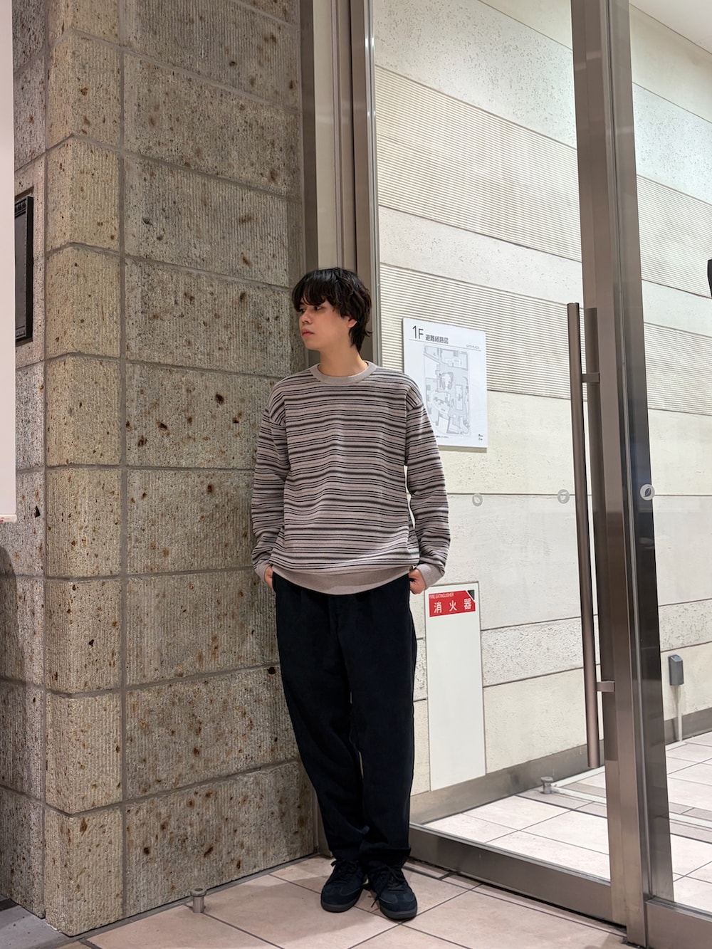 グリーン系のニット/セーター、ブルー系のその他パンツ、ブラック系のスニーカーを着用したメンズの冬コーディネートの3枚目の写真