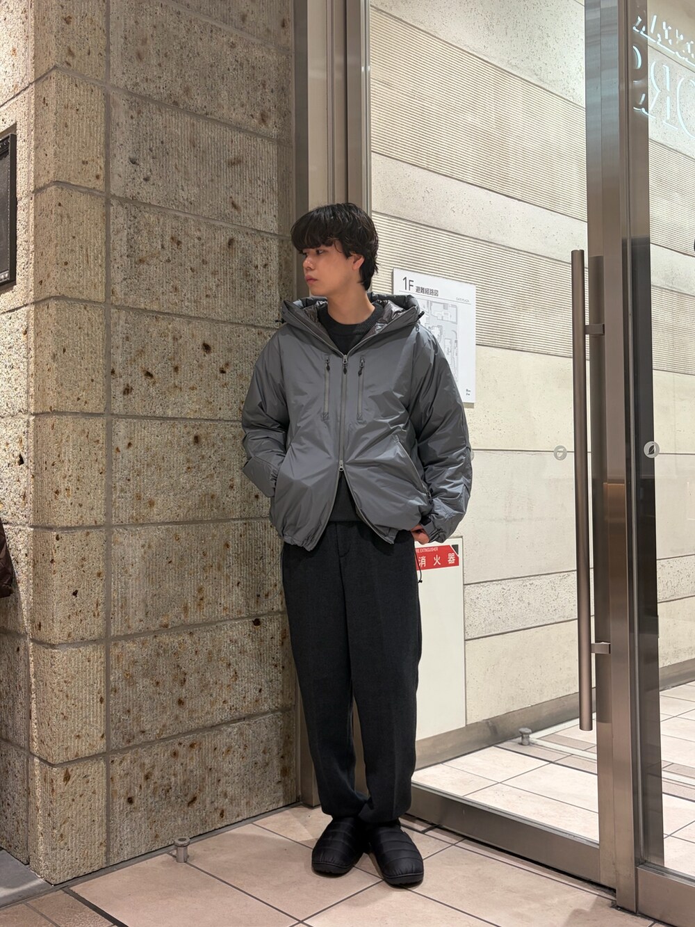 グレー系のダウンジャケット/コート、ブラック系のその他シューズ、ブルー系のその他パンツを着用したメンズの冬コーディネートの3枚目の写真