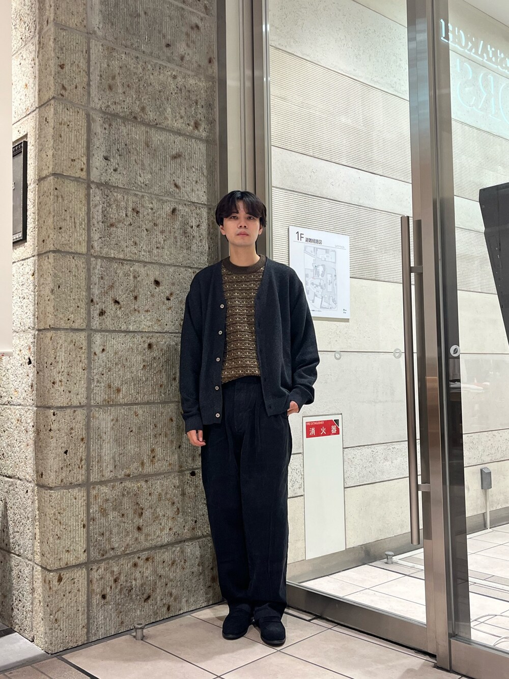 グレー系のカーディガン/ボレロ、ブラウン系のニット/セーター、グレー系のその他パンツを着用したメンズの秋コーディネートの2枚目の写真