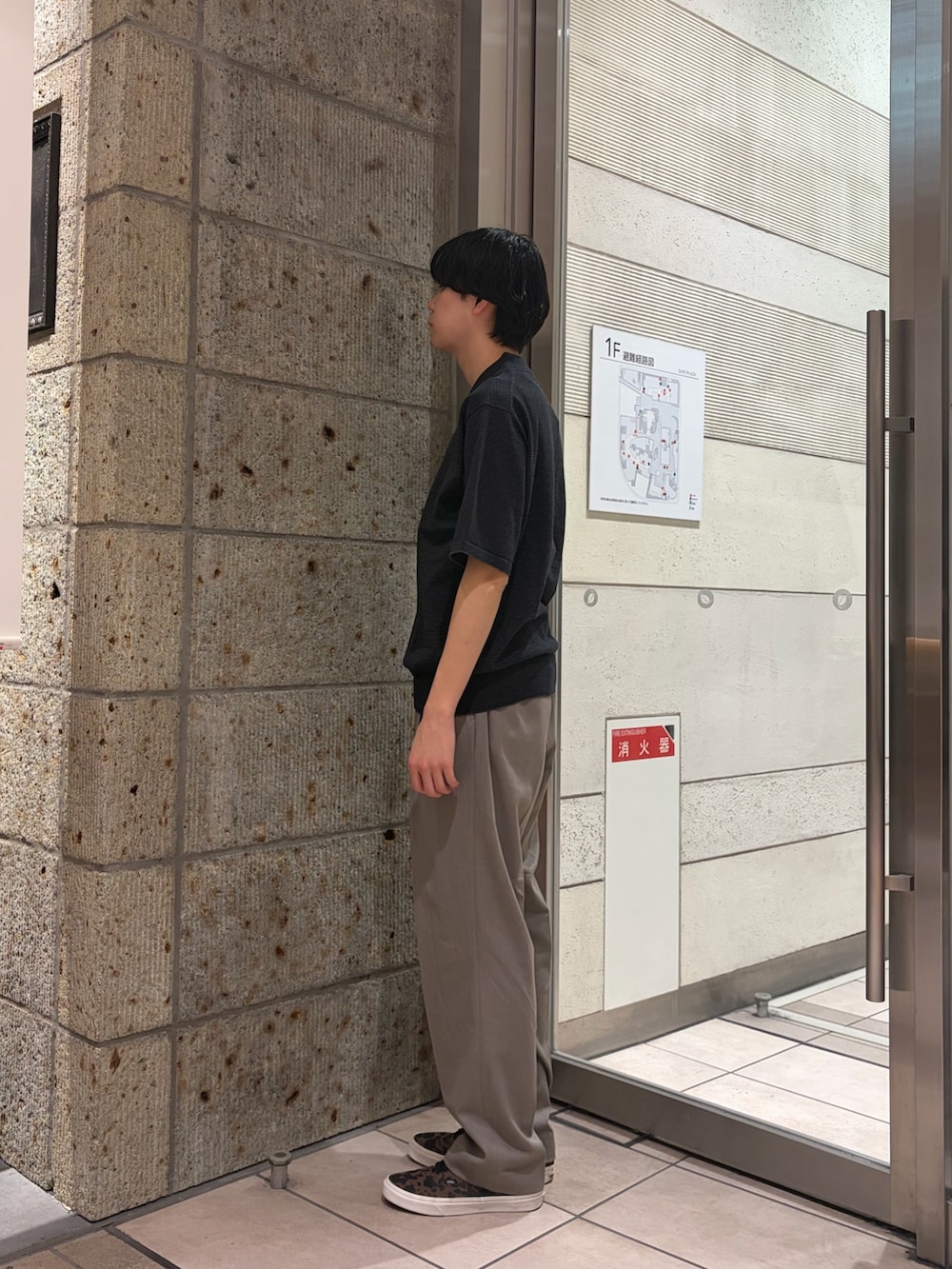 グレー系のニット/セーター、ベージュ系のその他パンツ、ブラウン系のスニーカーを着用したメンズの春コーディネートの3枚目の写真