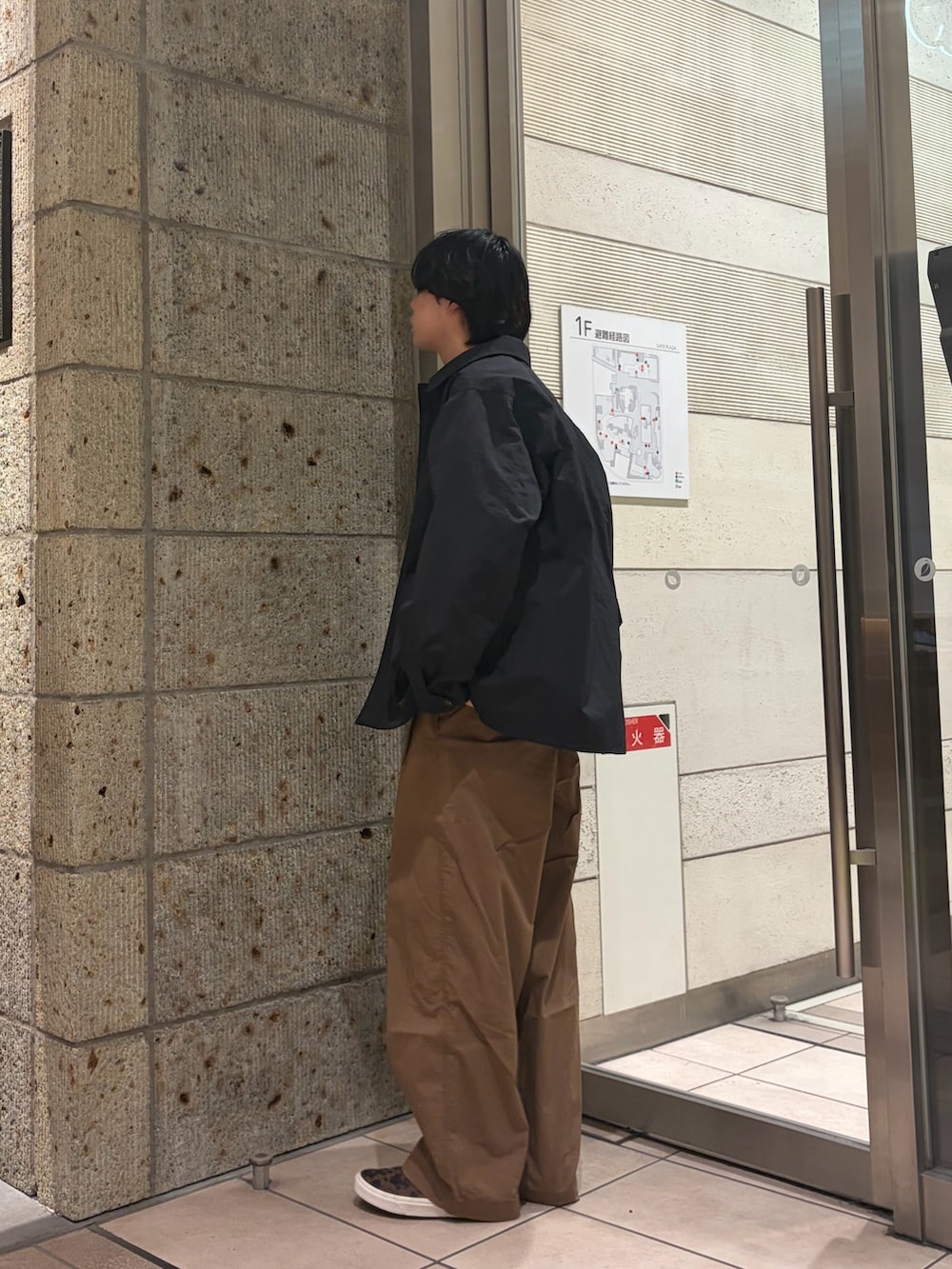 ブラック系のナイロンジャケット、ブルー系のデニムジャケット、イエロー系のTシャツ/カットソーを着用したメンズの春コーディネートの4枚目の写真