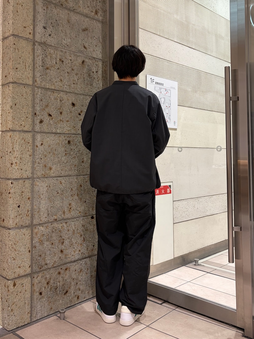 グレー系のブルゾン、ホワイト系のTシャツ/カットソー、ブラック系のその他パンツを着用したメンズの春コーディネートの3枚目の写真