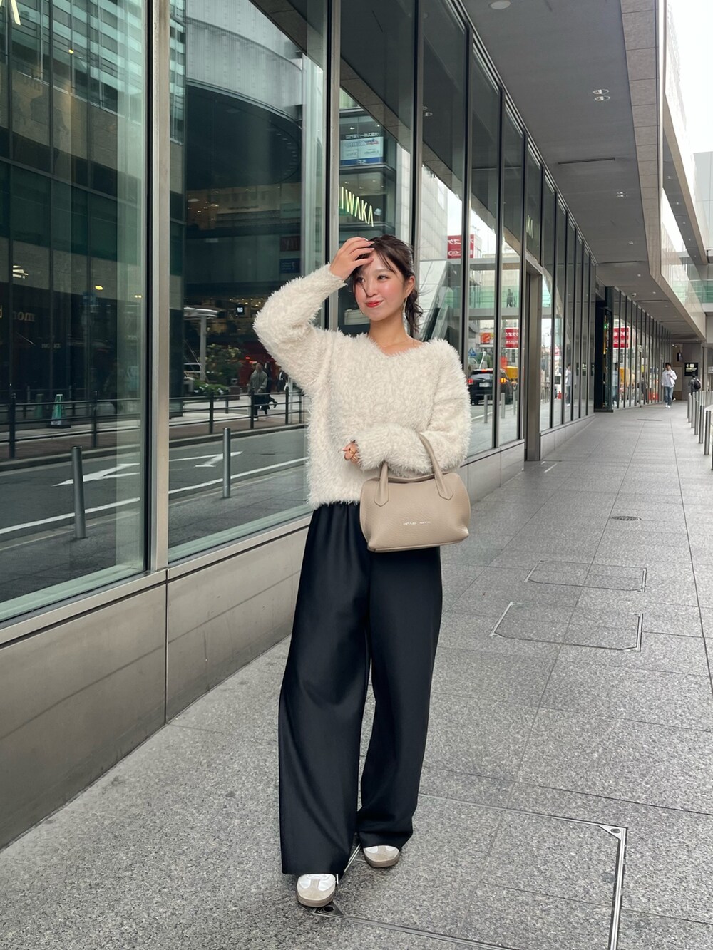 ベージュ系のショルダーバッグを着用したレディースの秋コーディネートの3枚目の写真