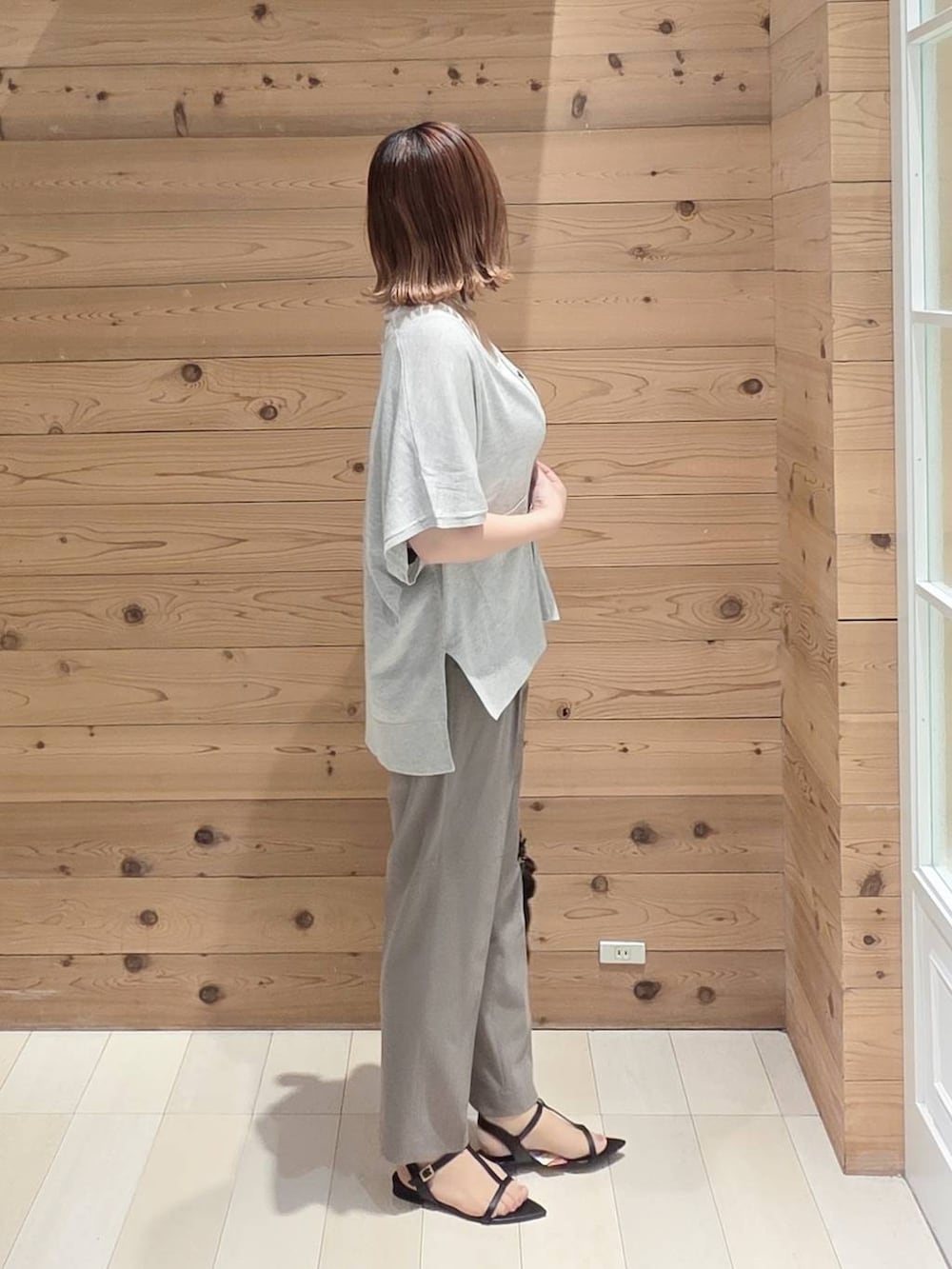 グレー系のカーディガン/ボレロ、ブラウン系のその他パンツ、ホワイト系のタンクトップを着用したレディースの夏コーディネートの2枚目の写真