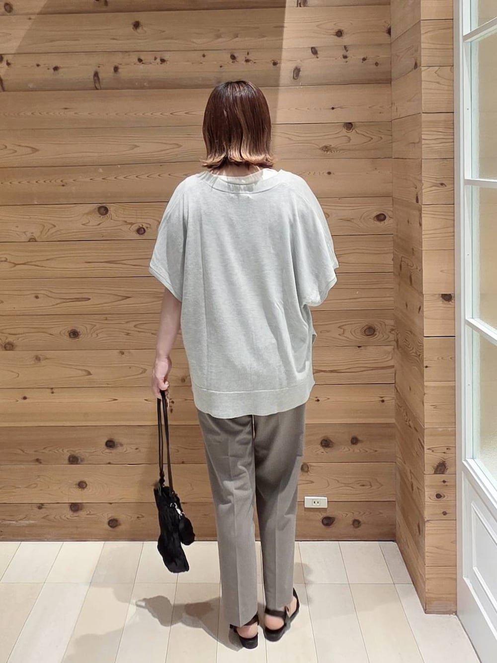 グレー系のカーディガン/ボレロ、ブラウン系のその他パンツ、ホワイト系のタンクトップを着用したレディースの夏コーディネートの3枚目の写真