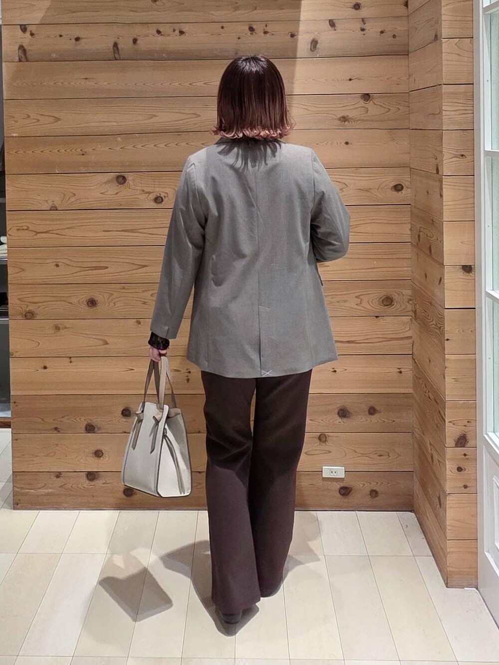 ブラック系のパンプス、ホワイト系のショルダーバッグ、ブラック系のTシャツ/カットソーを着用したレディースの冬コーディネートの3枚目の写真