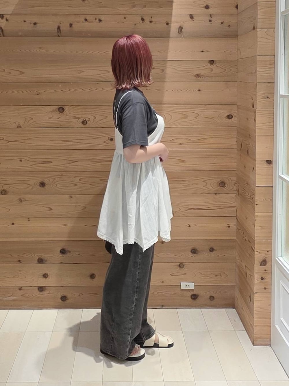 ホワイト系のシャツ/ブラウス、ブラック系のハンドバッグ、ブラック系のデニムパンツを着用したレディースの夏コーディネートの2枚目の写真