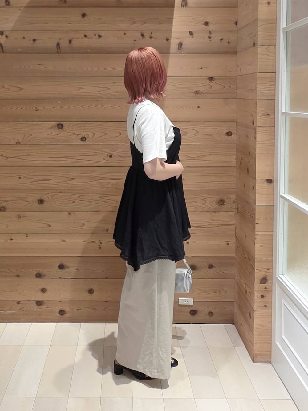 ブラック系のシャツ/ブラウス、シルバー系のショルダーバッグ、ベージュ系のその他パンツを着用したレディースの夏コーディネートの2枚目の写真