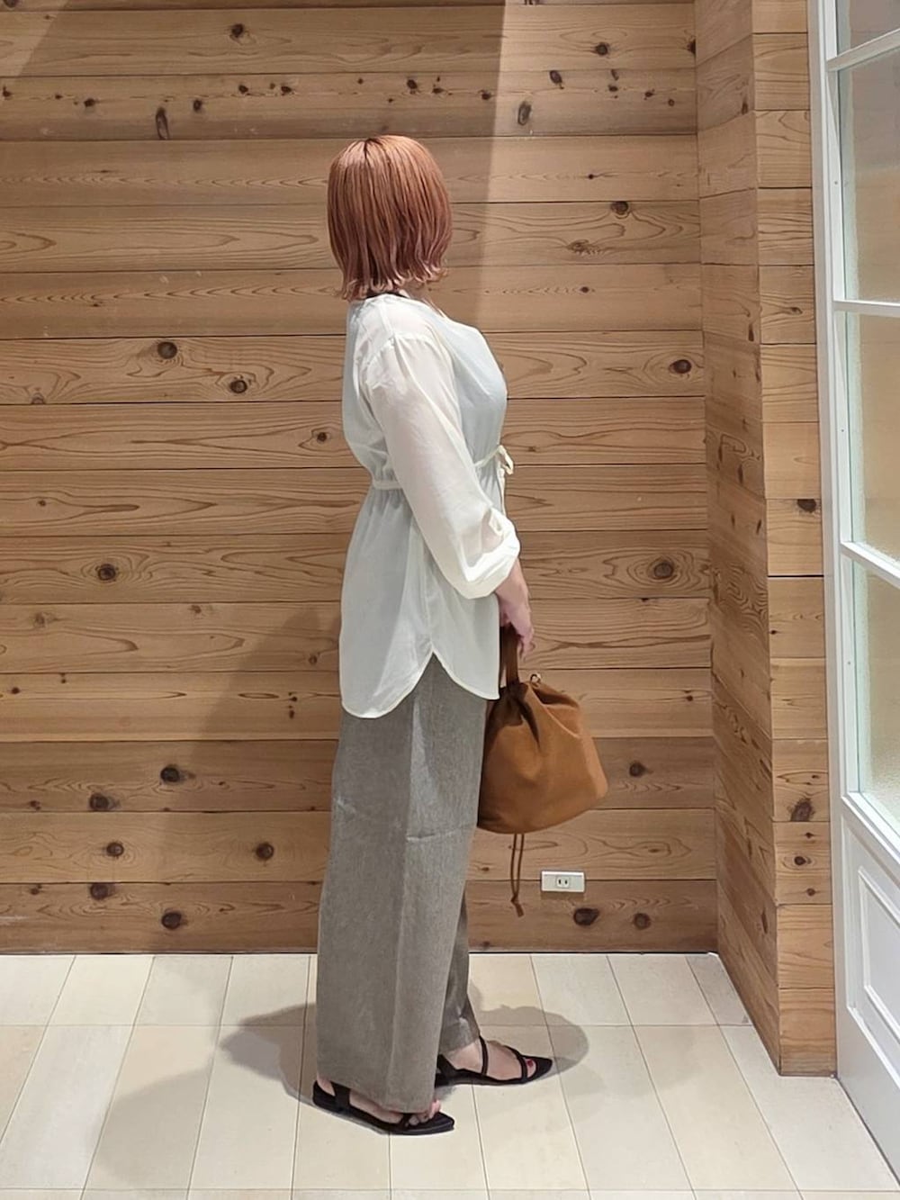 ベージュ系のハンドバッグ、ブラック系のタンクトップ、ベージュ系のその他パンツを着用したレディースの夏コーディネートの2枚目の写真