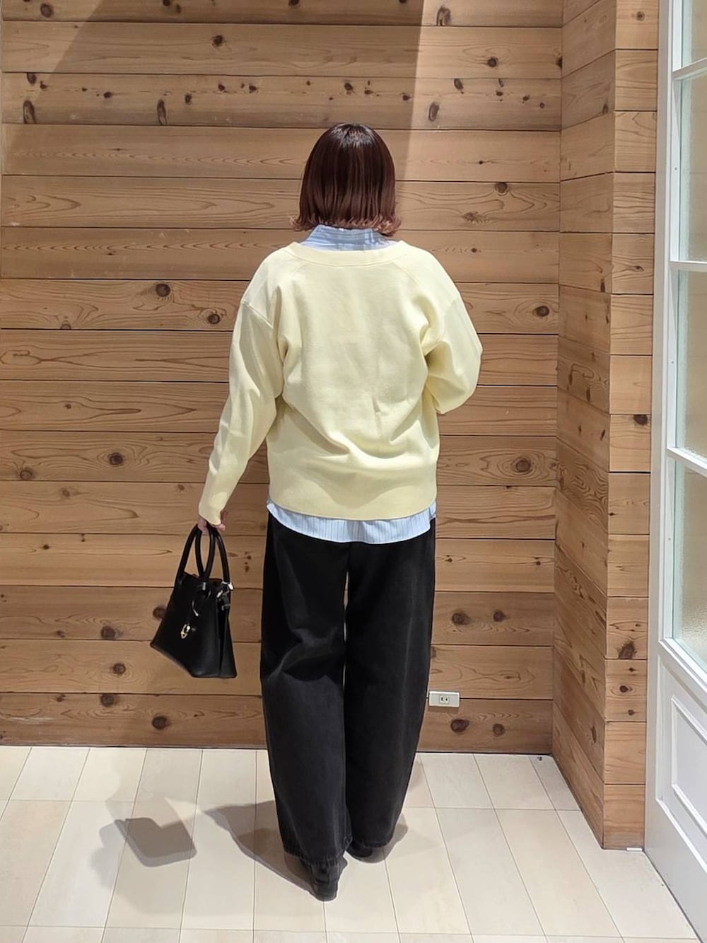 ブラック系のローファー、ブラック系のショルダーバッグ、ブルー系のシャツ/ブラウスを着用したレディースの春コーディネートの3枚目の写真