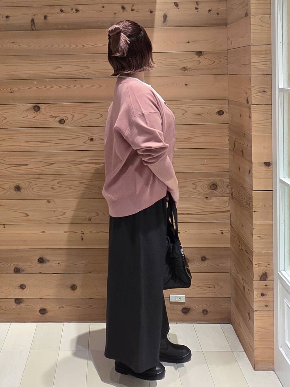 ブラック系のトートバッグ、ピンク系のカーディガン/ボレロ、ブラック系のその他パンツを着用したレディースの秋コーディネートの2枚目の写真