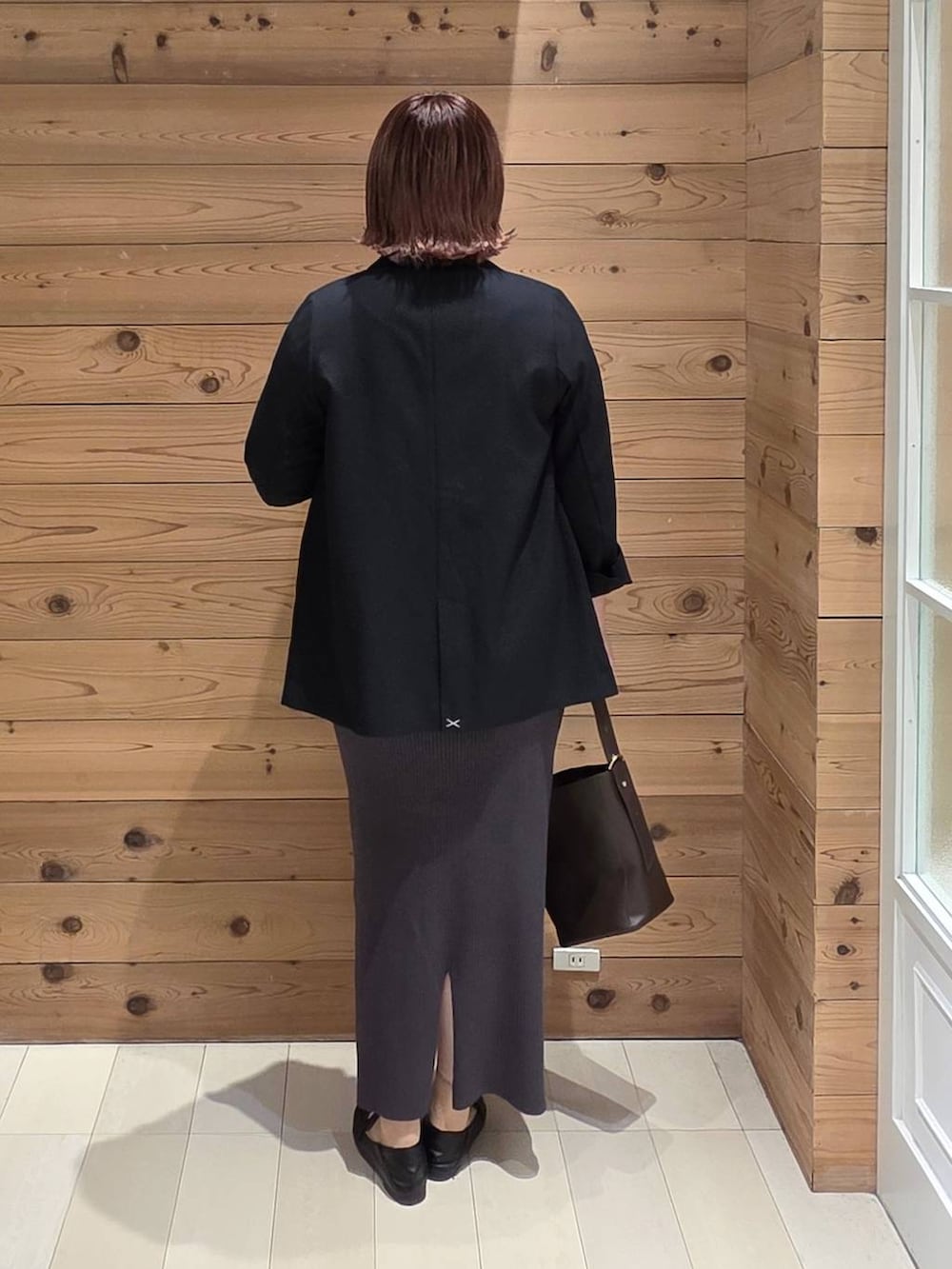 ブラック系のローファー、ブラウン系のショルダーバッグ、ブルー系のテーラードジャケットを着用したレディースの秋コーディネートの3枚目の写真