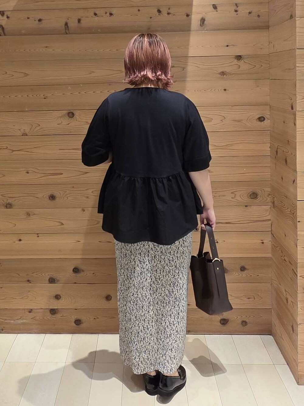 ブラック系のローファー、ブラウン系のショルダーバッグ、グレー系のスカートを着用したレディースの秋コーディネートの3枚目の写真