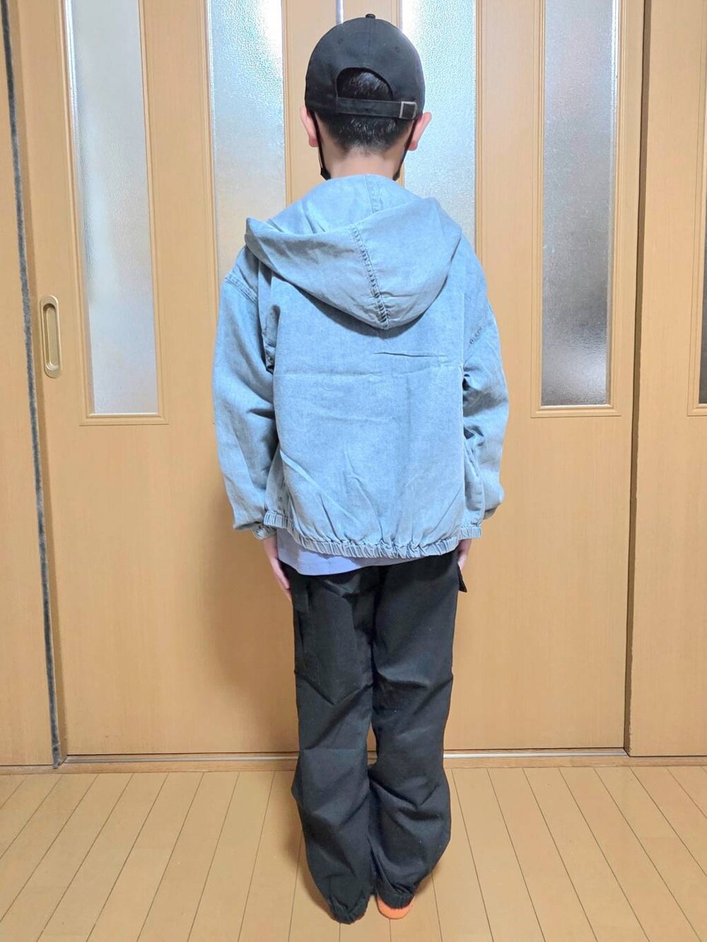 ブルー系のパーカー、ブラック系のカーゴパンツ、ブルー系のTシャツ/カットソーを着用したキッズの秋コーディネートの3枚目の写真