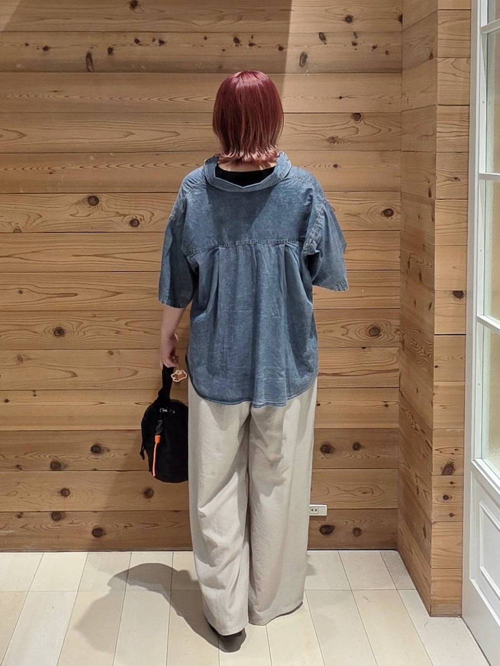 ブラック系のハンドバッグ、ベージュ系のその他パンツ、ブラック系のタンクトップを着用したレディースの夏コーディネートの3枚目の写真
