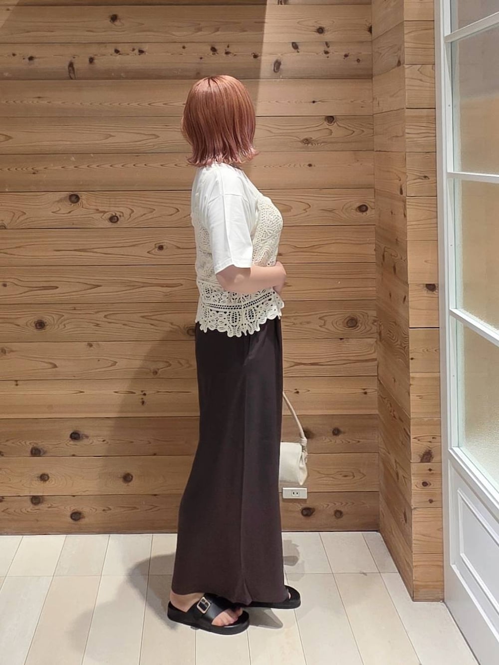 ベージュ系のショルダーバッグ、ブラウン系のその他パンツ、ホワイト系のTシャツ/カットソーを着用したレディースの夏コーディネートの2枚目の写真