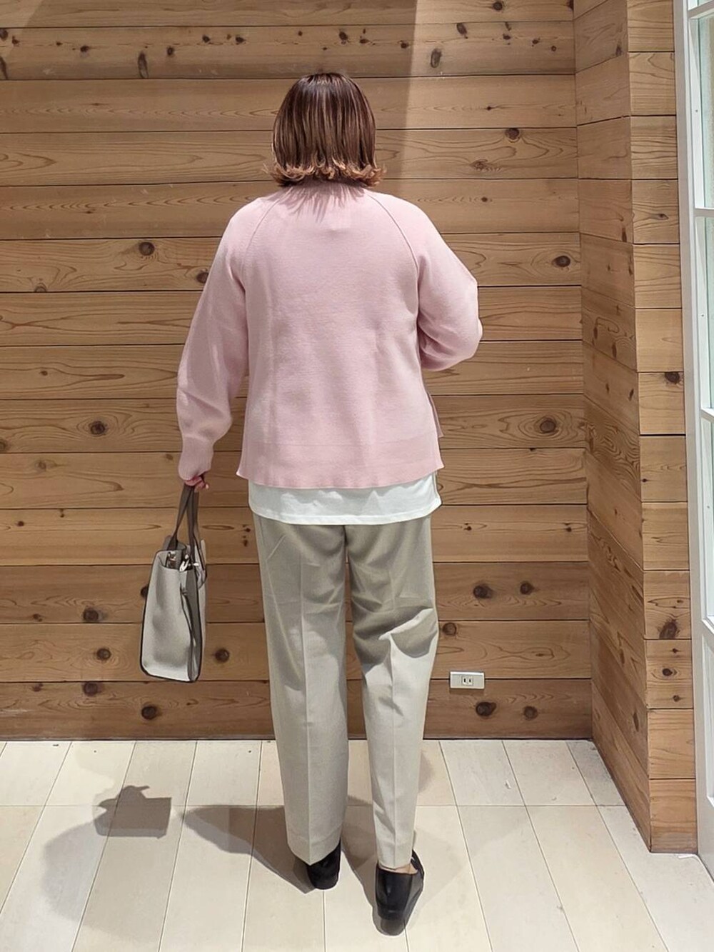 ブラック系のローファー、ホワイト系のショルダーバッグ、ブルー系のダウンジャケット/コートを着用したレディースの冬コーディネートの3枚目の写真