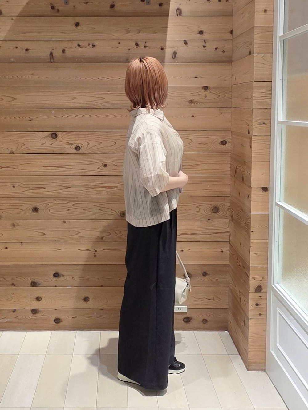 ベージュ系のショルダーバッグ、ブラック系のその他パンツ、ベージュ系のシャツ/ブラウスを着用したレディースの夏コーディネートの2枚目の写真
