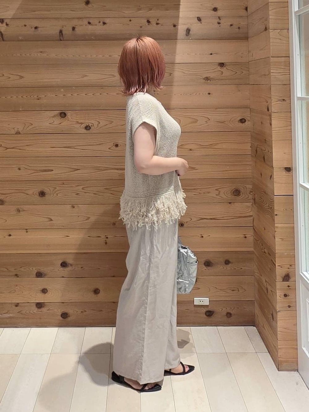 シルバー系のトートバッグ、ベージュ系のその他パンツ、ブラック系のタンクトップを着用したレディースの夏コーディネートの2枚目の写真