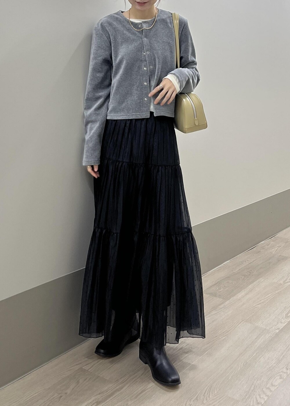 ホワイト系のTシャツ/カットソー、ブラック系のブーツ、グレー系のカーディガン/ボレロを着用したレディースの秋コーディネートの8枚目の写真