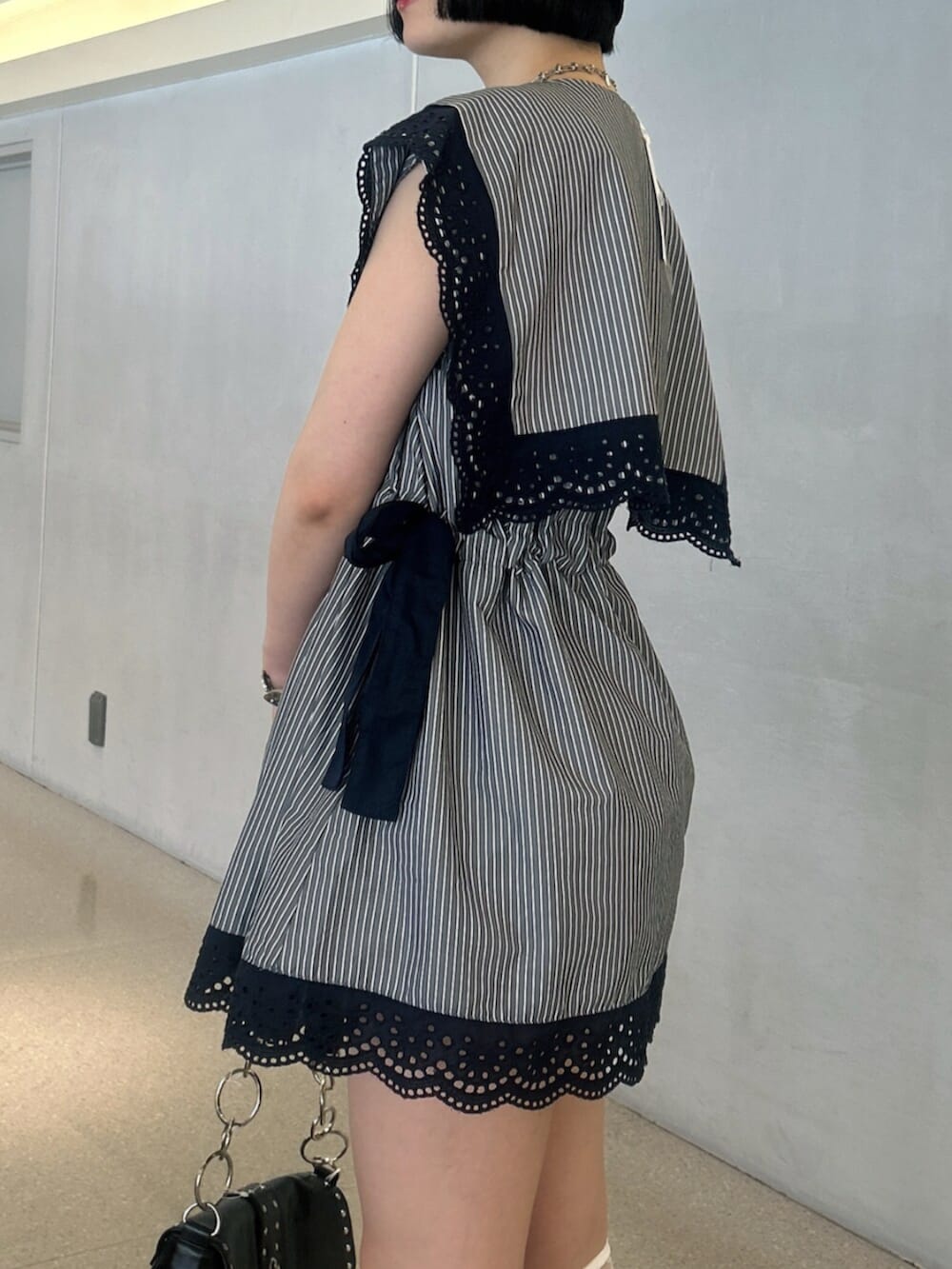 グレー系のシャツ/ブラウス、ブラック系のパンプス、ブラック系のハンドバッグを着用したレディースの夏コーディネートの5枚目の写真