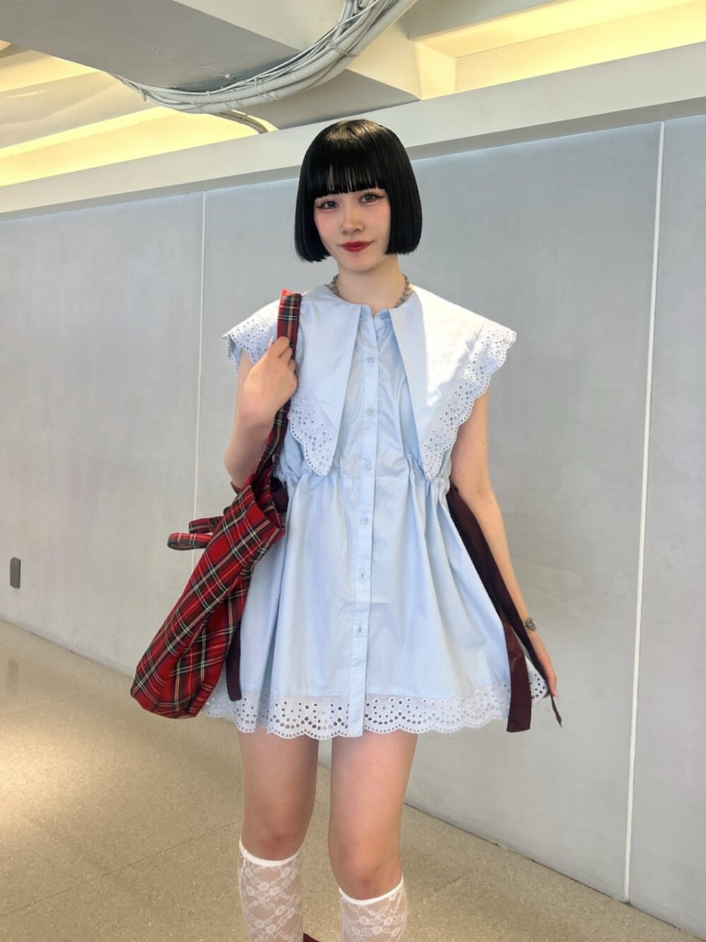 ブルー系のシャツ/ブラウス、レッド系のトートバッグ、レッド系のパンプスを着用したレディースの夏コーディネートの5枚目の写真