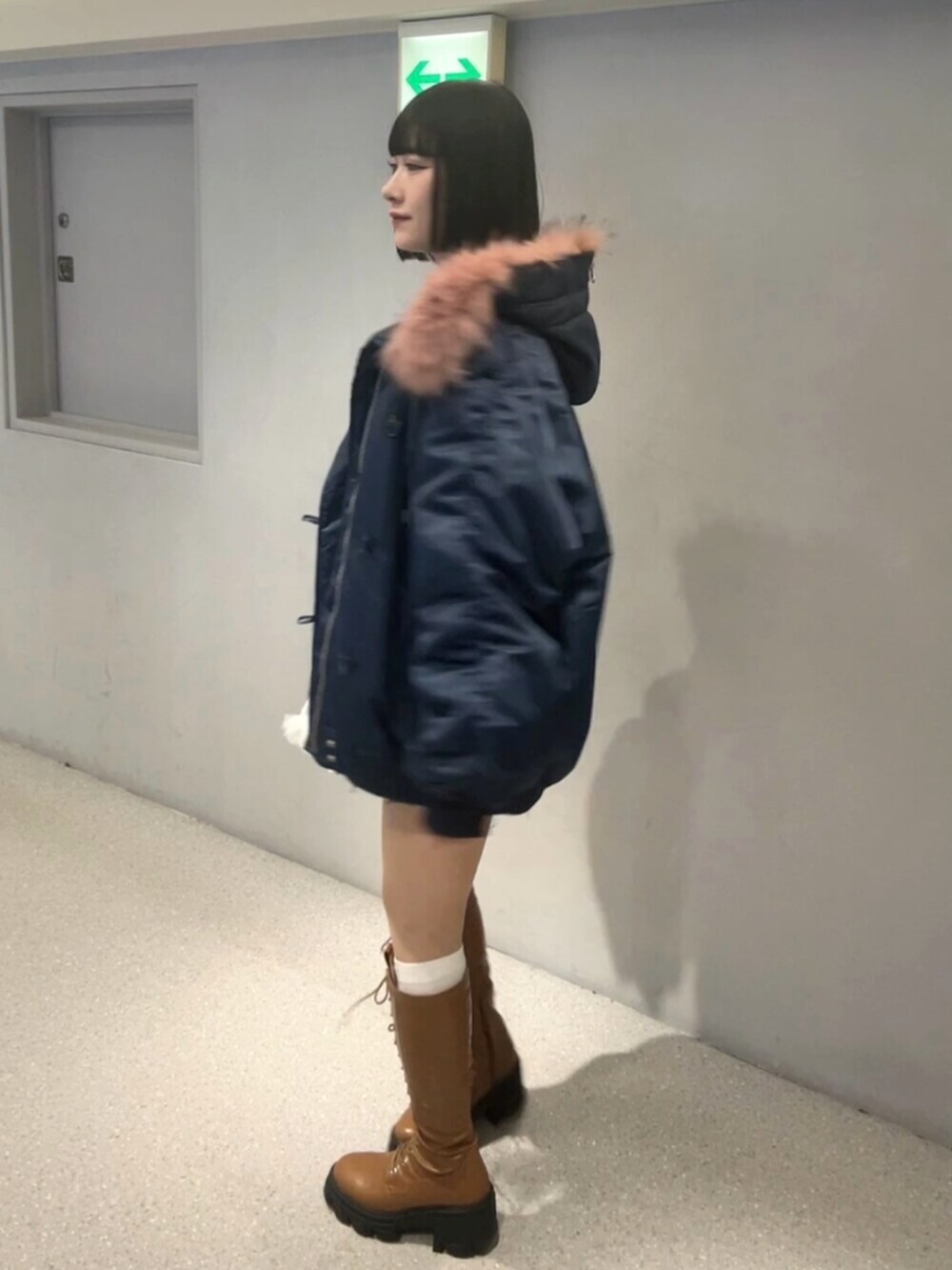 ブラウン系のブーツ、ブルー系のブルゾン、グレー系のカーディガン/ボレロを着用したレディースの秋コーディネートの4枚目の写真