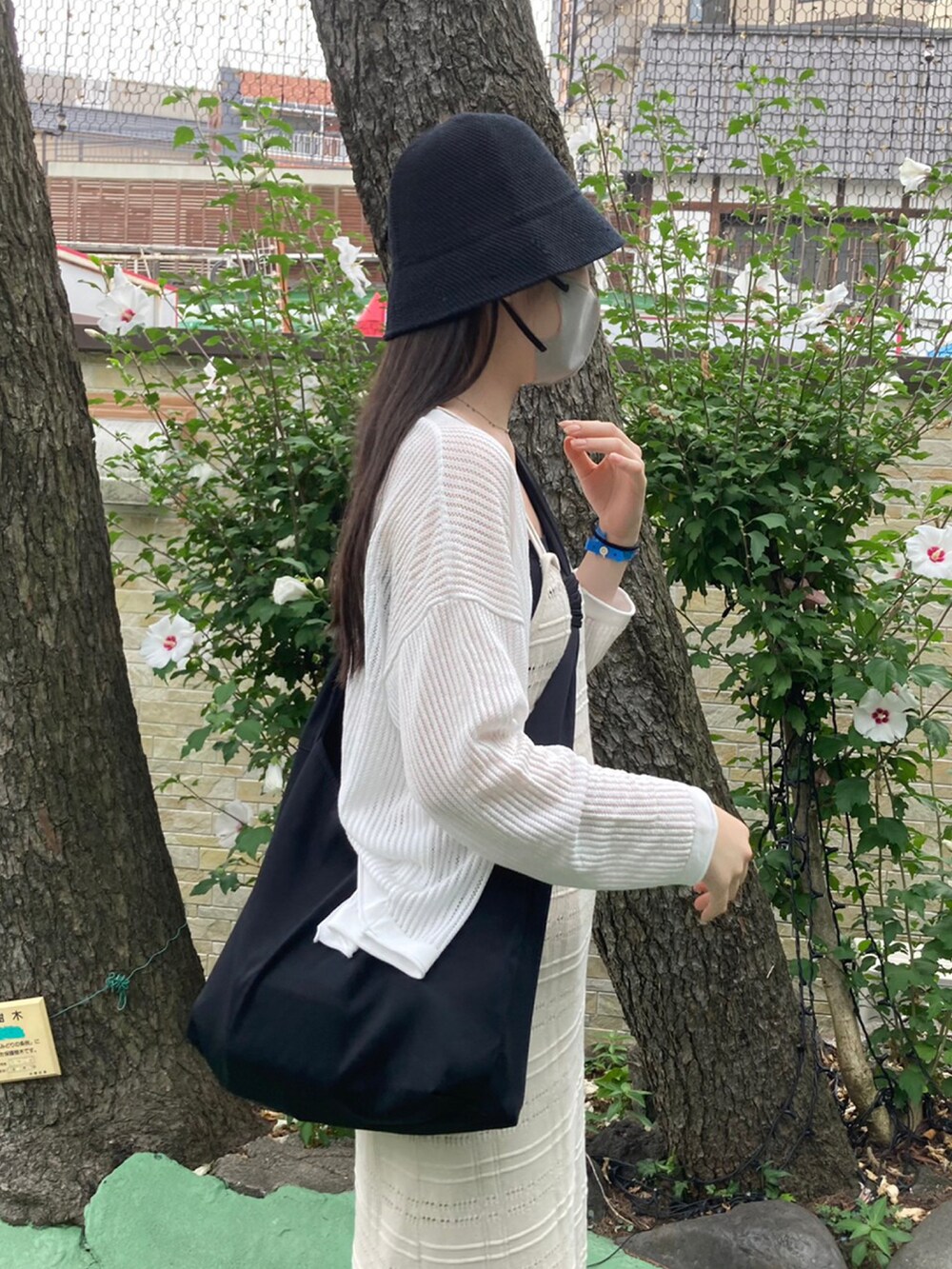 ホワイト系のワンピース、ホワイト系のスラックス、ブラック系のサンダルを着用したレディースの冬コーディネートの3枚目の写真