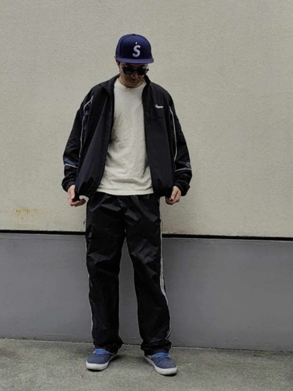 ブルー系のスニーカー、ブラック系のその他パンツ、ブラック系のナイロンジャケットを着用したメンズの春コーディネートの3枚目の写真
