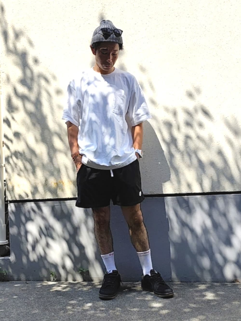 ホワイト系のTシャツ/カットソー、ブラック系のスウェットパンツ、ブラック系のスニーカーを着用したメンズの夏コーディネートの2枚目の写真