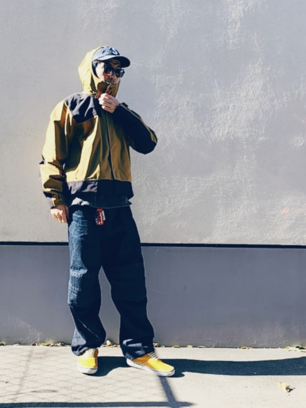 ブラック系のデニムパンツ、イエロー系のスニーカー、ブラック系のスウェットを着用したメンズの秋コーディネートの2枚目の写真