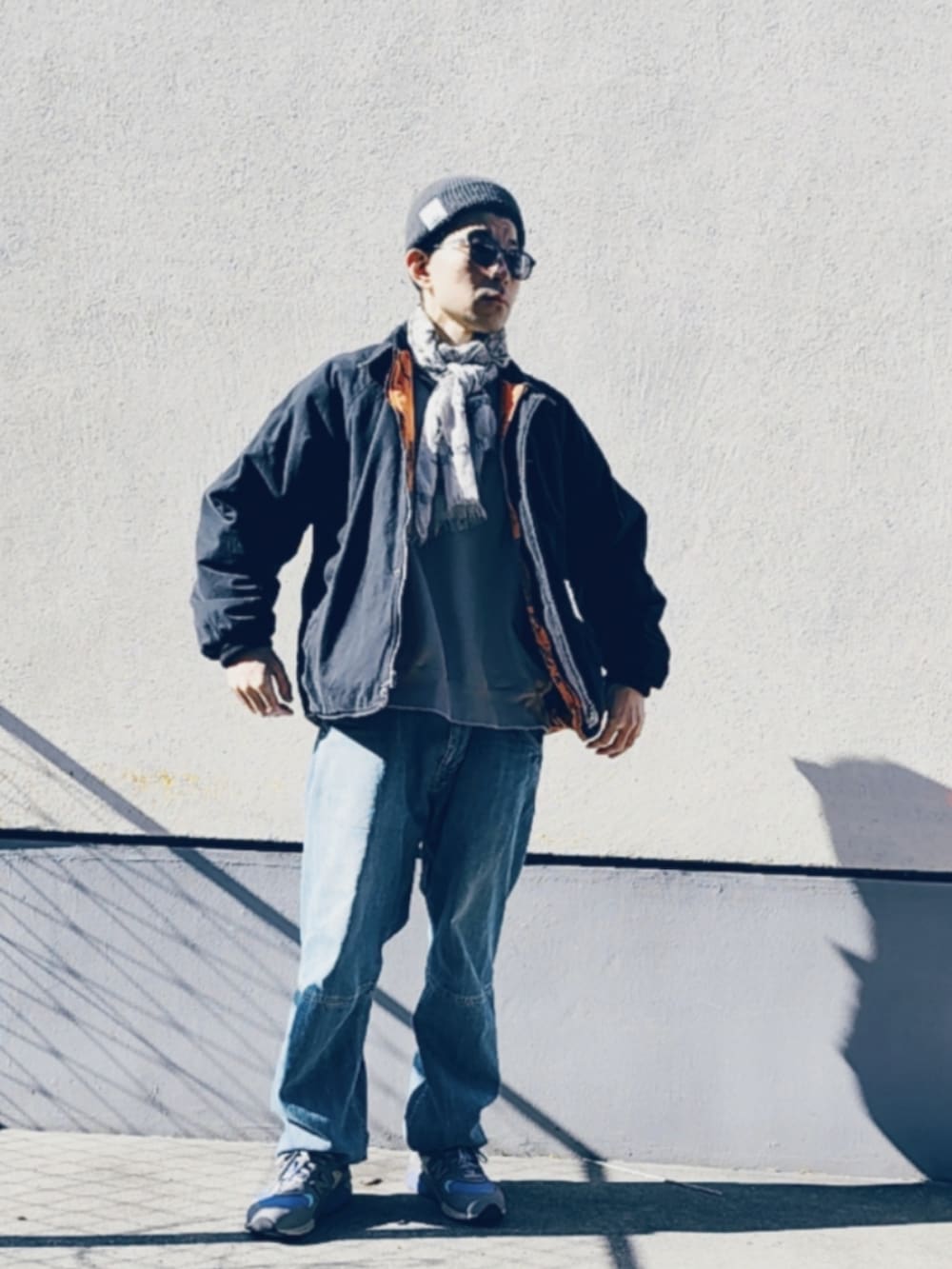 ブラック系のブルゾン、ブルー系のデニムパンツ、パープル系のスニーカーを着用したメンズの冬コーディネートの3枚目の写真