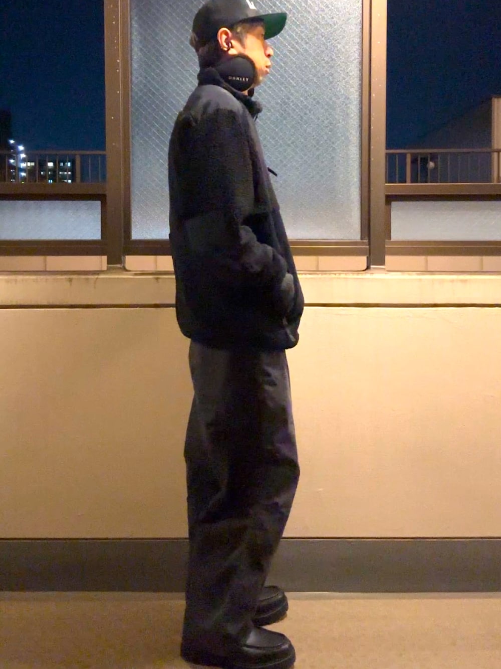 ブラック系のその他アウター、ブラック系のダウンベスト、ブラック系のデニムパンツを着用したメンズの冬コーディネートの2枚目の写真