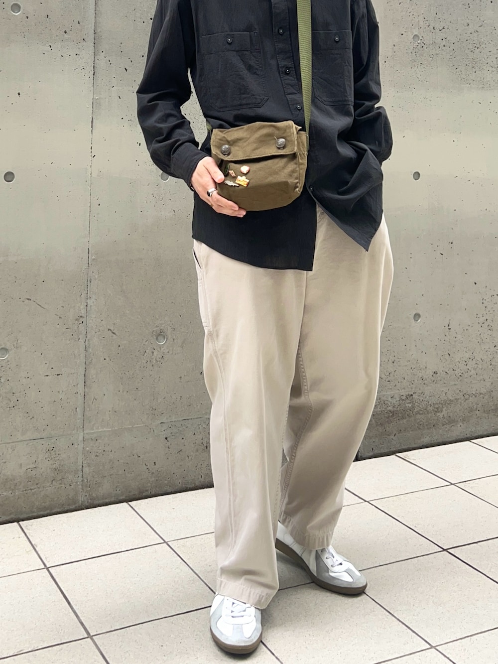 ブラック系のシャツ/ブラウス、ホワイト系のパンツ、ホワイト系のスニーカーを着用したメンズの春コーディネートの3枚目の写真