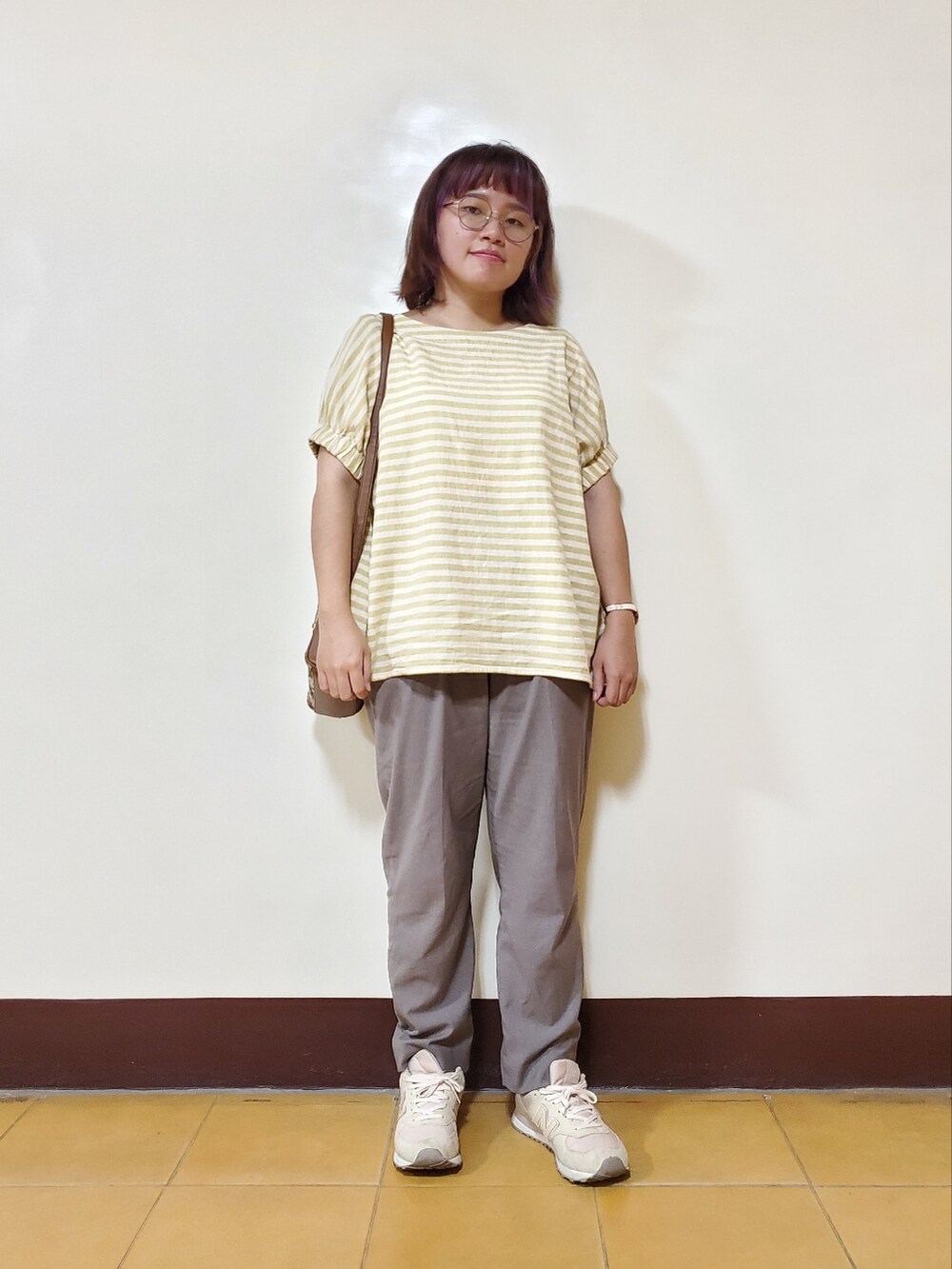 イエロー系のシャツ/ブラウス、グレー系のスラックス、ベージュ系のシューズを着用したレディースの秋コーディネートの2枚目の写真