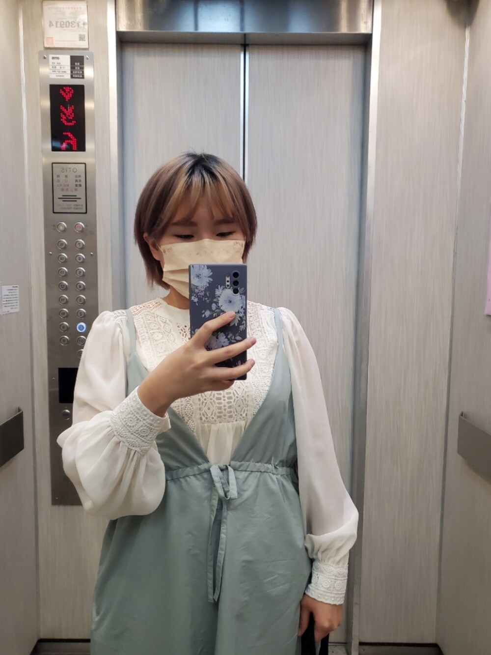 グリーン系のジャンパースカート、ホワイト系のトップス、ホワイト系のキャミソールを着用したレディースの夏コーディネートの3枚目の写真