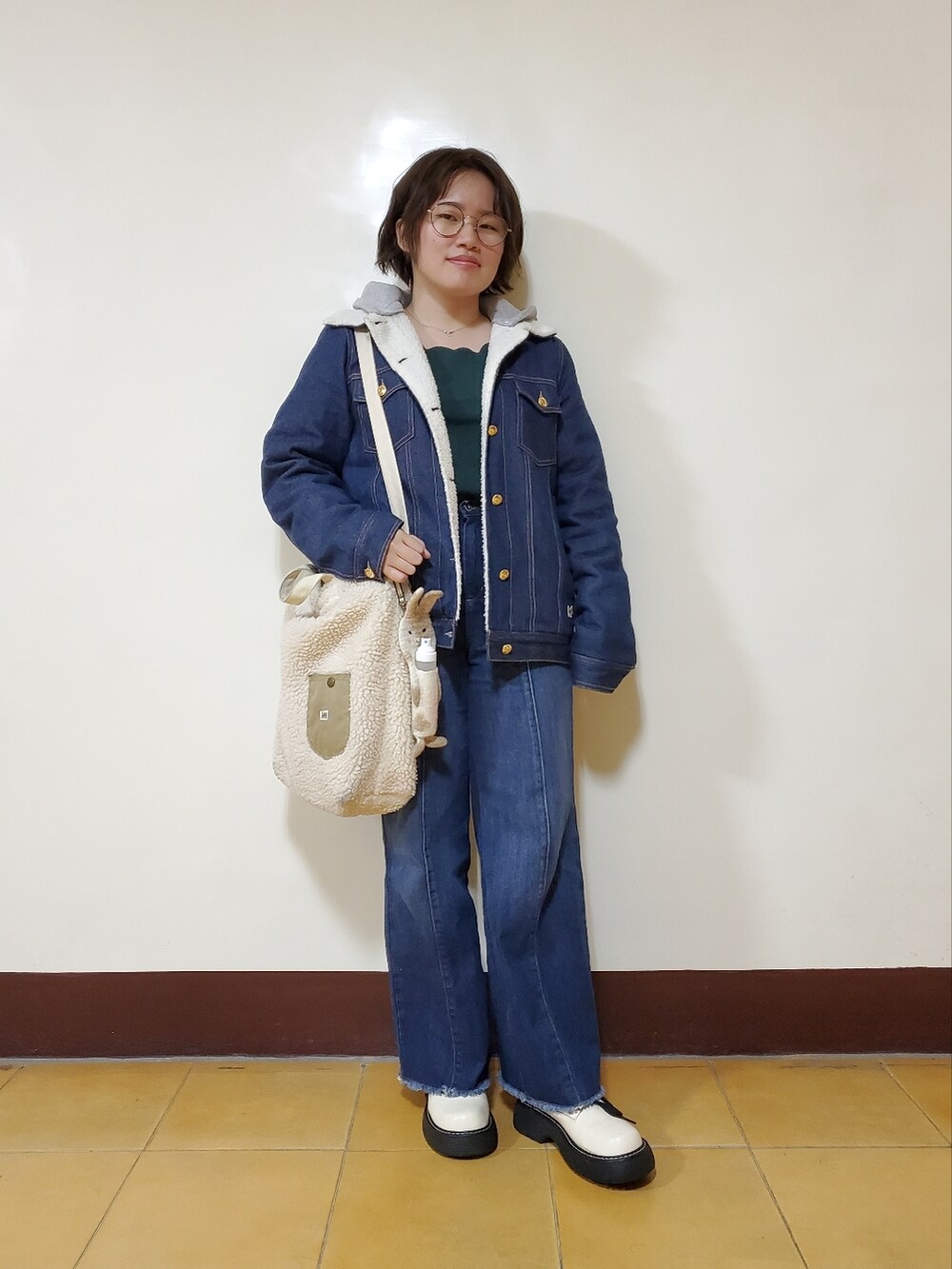 ブルー系のデニムジャケット、グリーン系のTシャツ/カットソー、ブルー系のデニムパンツを着用したレディースの春コーディネートの4枚目の写真