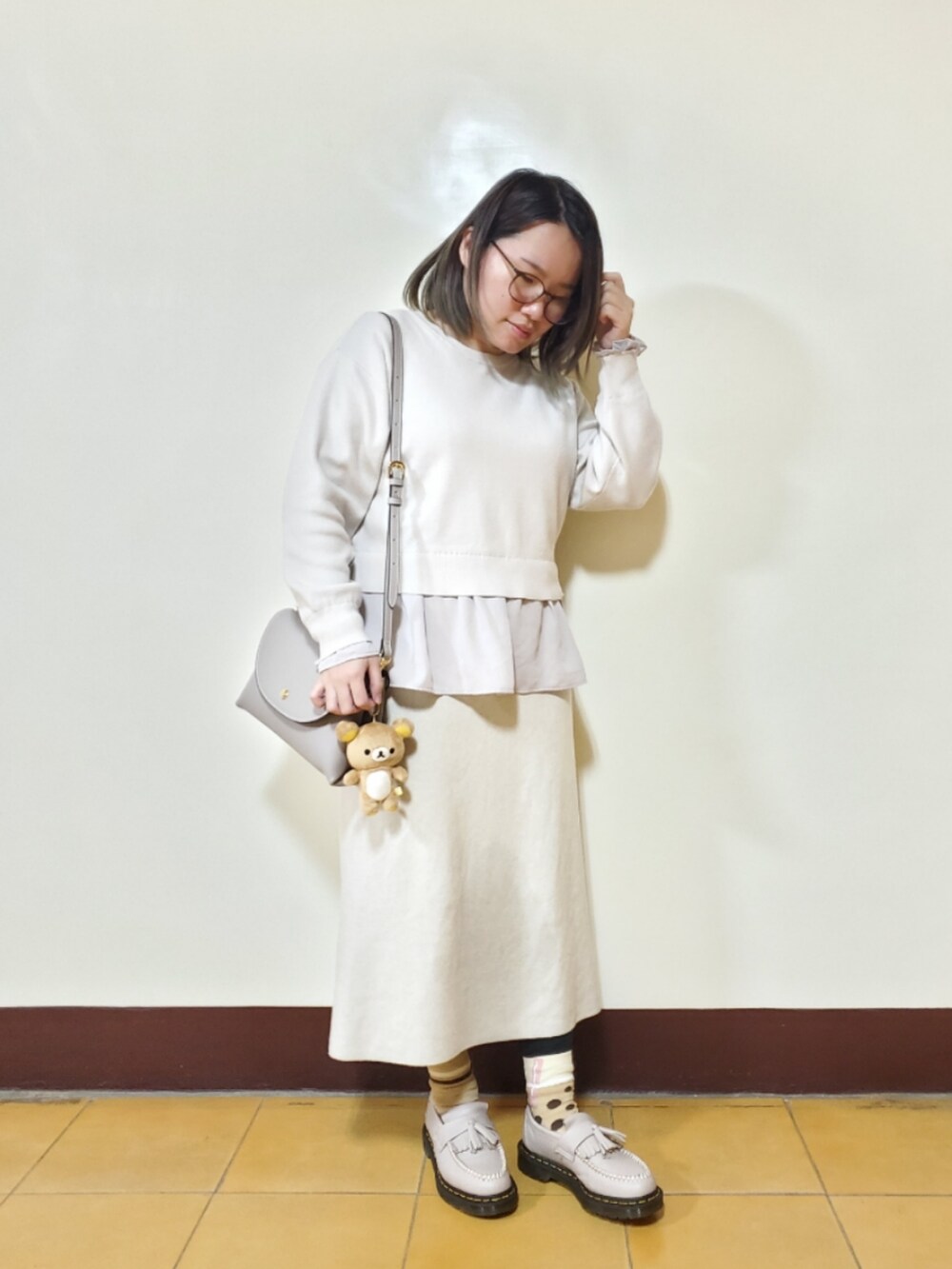 ベージュ系のダウンジャケット/コート、ベージュ系のニット/セーター、ベージュ系のスカートを着用したレディースの冬コーディネートの2枚目の写真